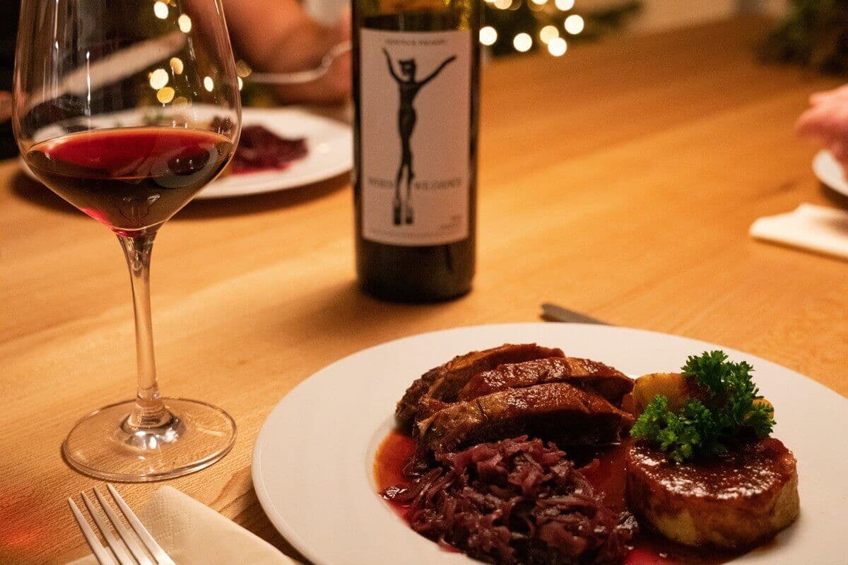 Plate of Christmas dinner with a glass of red wine